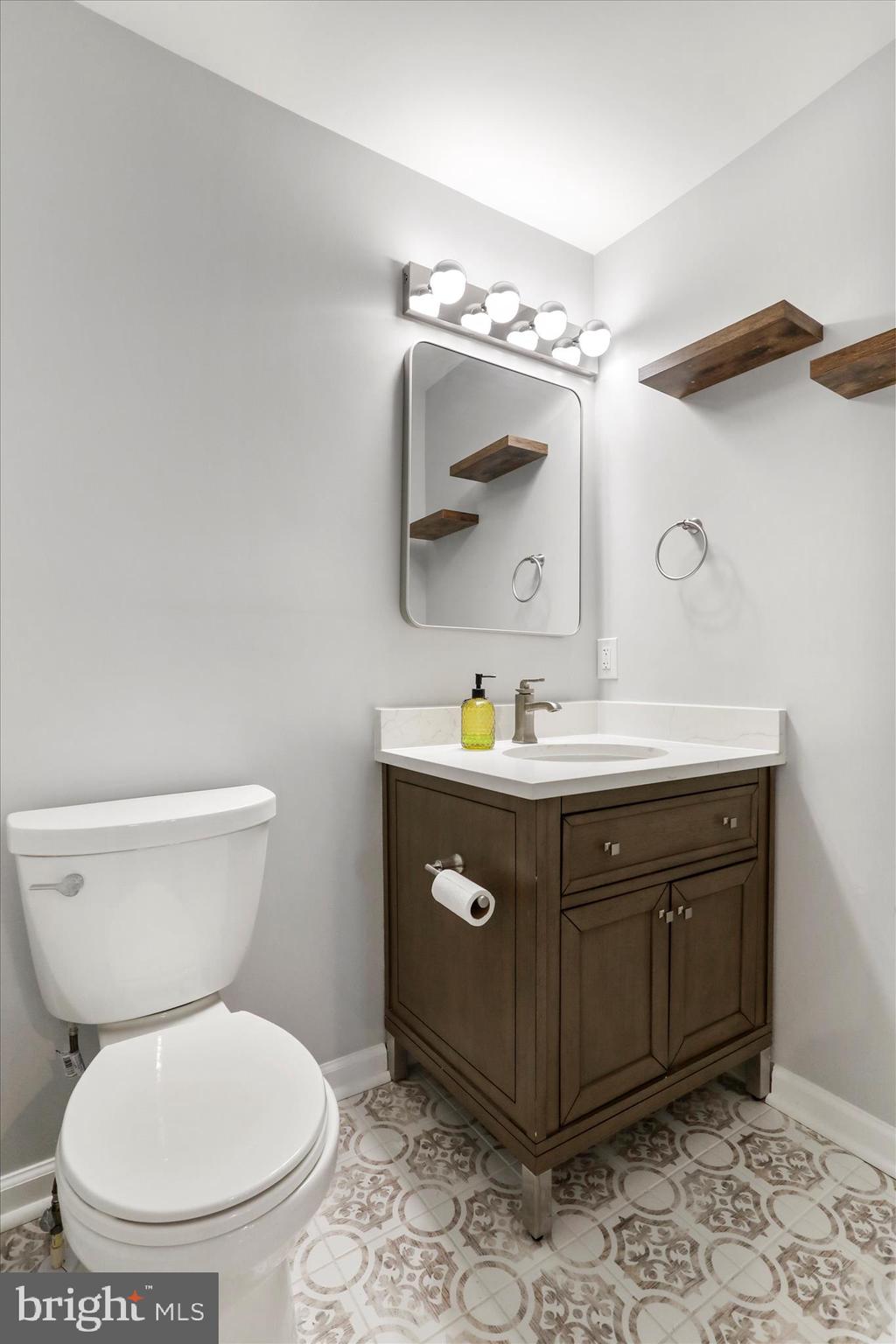 408 Blue Ridge Avenue Northeast Leesburg, VA 20176 - Photo 24 of 36 a bathroom with a toilet sink and mirror