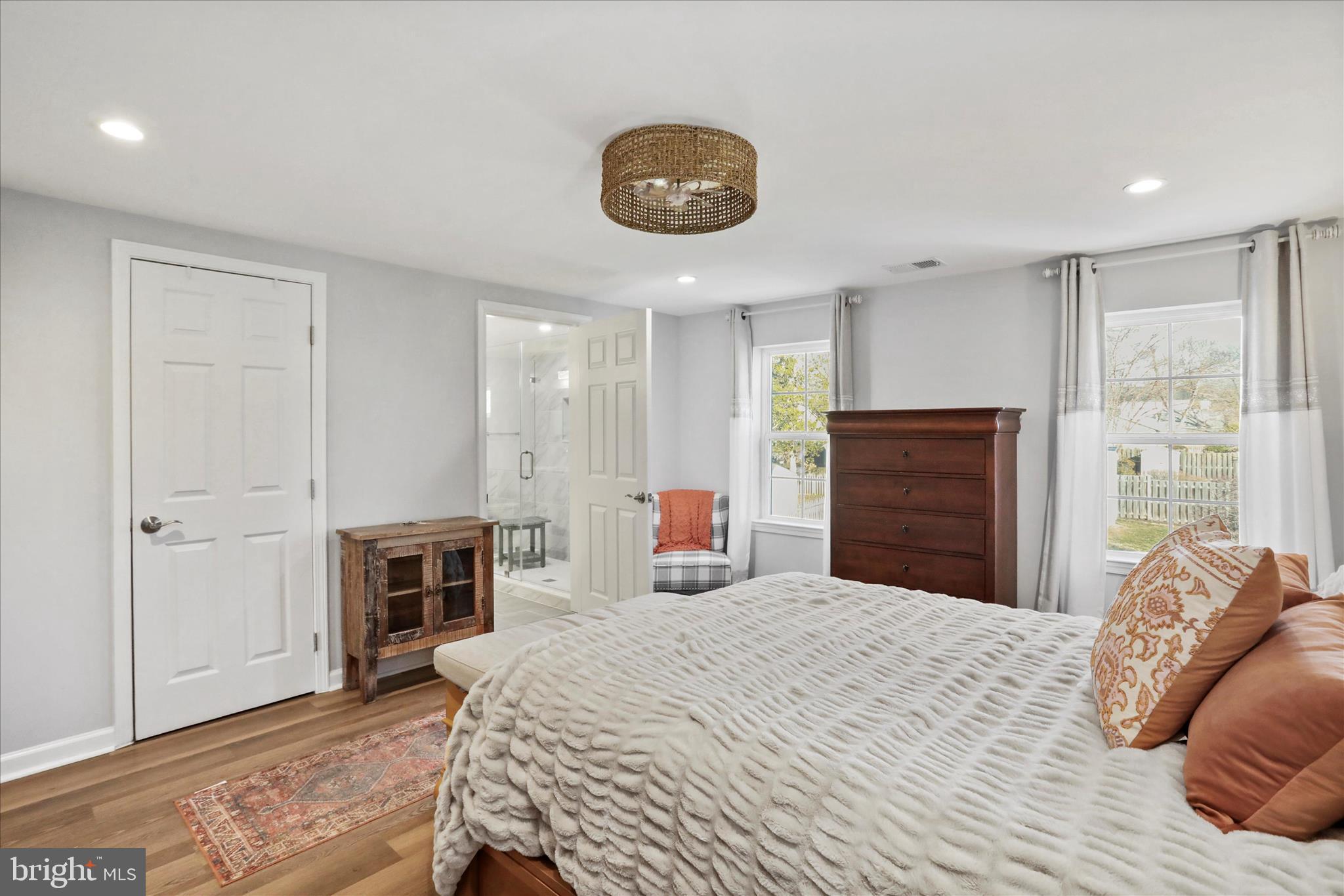 408 Blue Ridge Avenue Northeast Leesburg, VA 20176 - Photo 27 of 36 a bedroom with a large bed and a chandelier