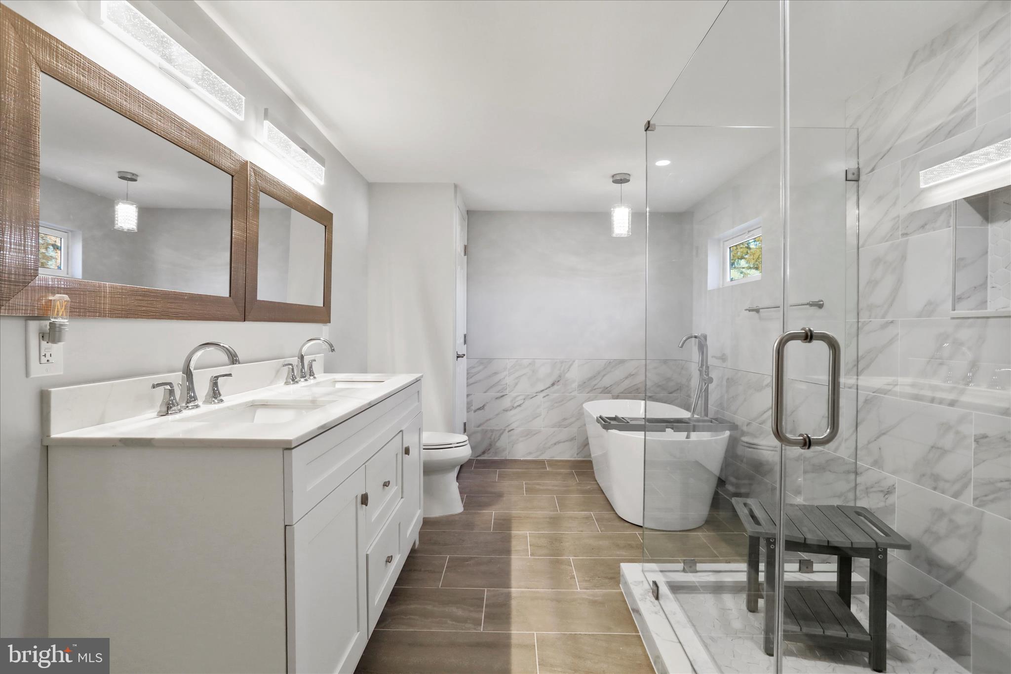 408 Blue Ridge Avenue Northeast Leesburg, VA 20176 - Photo 28 of 36 a bathroom with a double vanity sink a toilet and a mirror