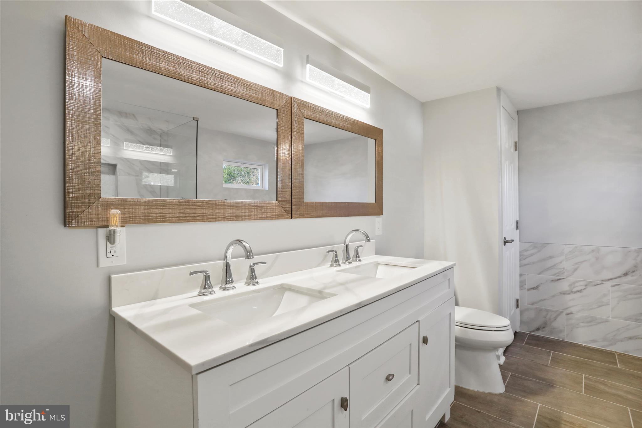 408 Blue Ridge Avenue Northeast Leesburg, VA 20176 - Photo 29 of 36 a bathroom with a toilet a sink a mirror and