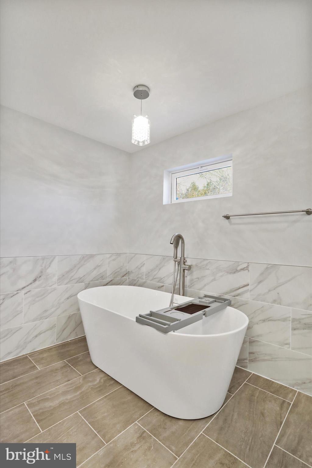 408 Blue Ridge Avenue Northeast Leesburg, VA 20176 - Photo 30 of 36 a white bath tub sitting in a bathroom