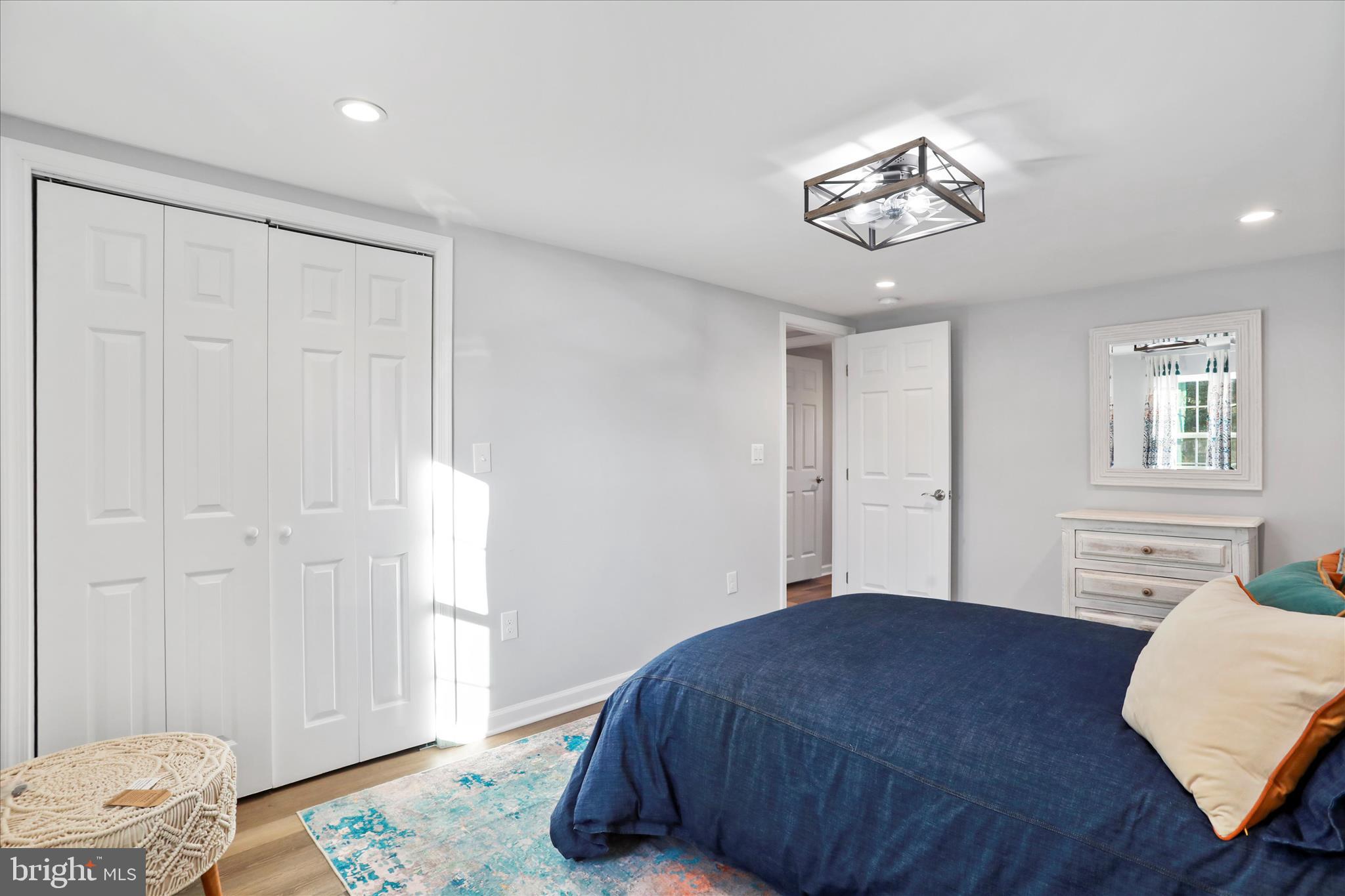 408 Blue Ridge Avenue Northeast Leesburg, VA 20176 - Photo 31 of 36 a bedroom with a bed and a chandelier