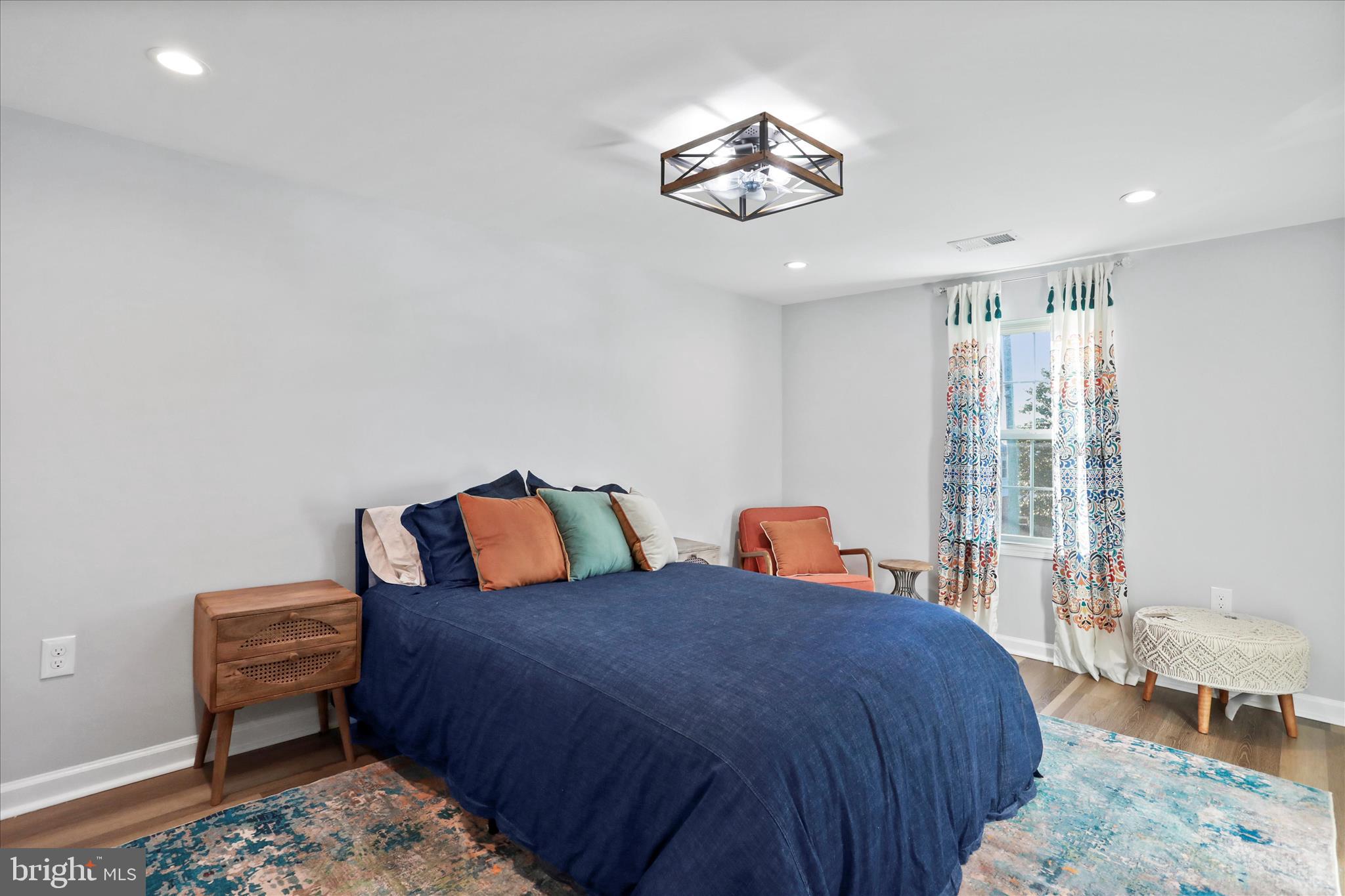 408 Blue Ridge Avenue Northeast Leesburg, VA 20176 - Photo 32 of 36 a bed room with a bed and a chandelier