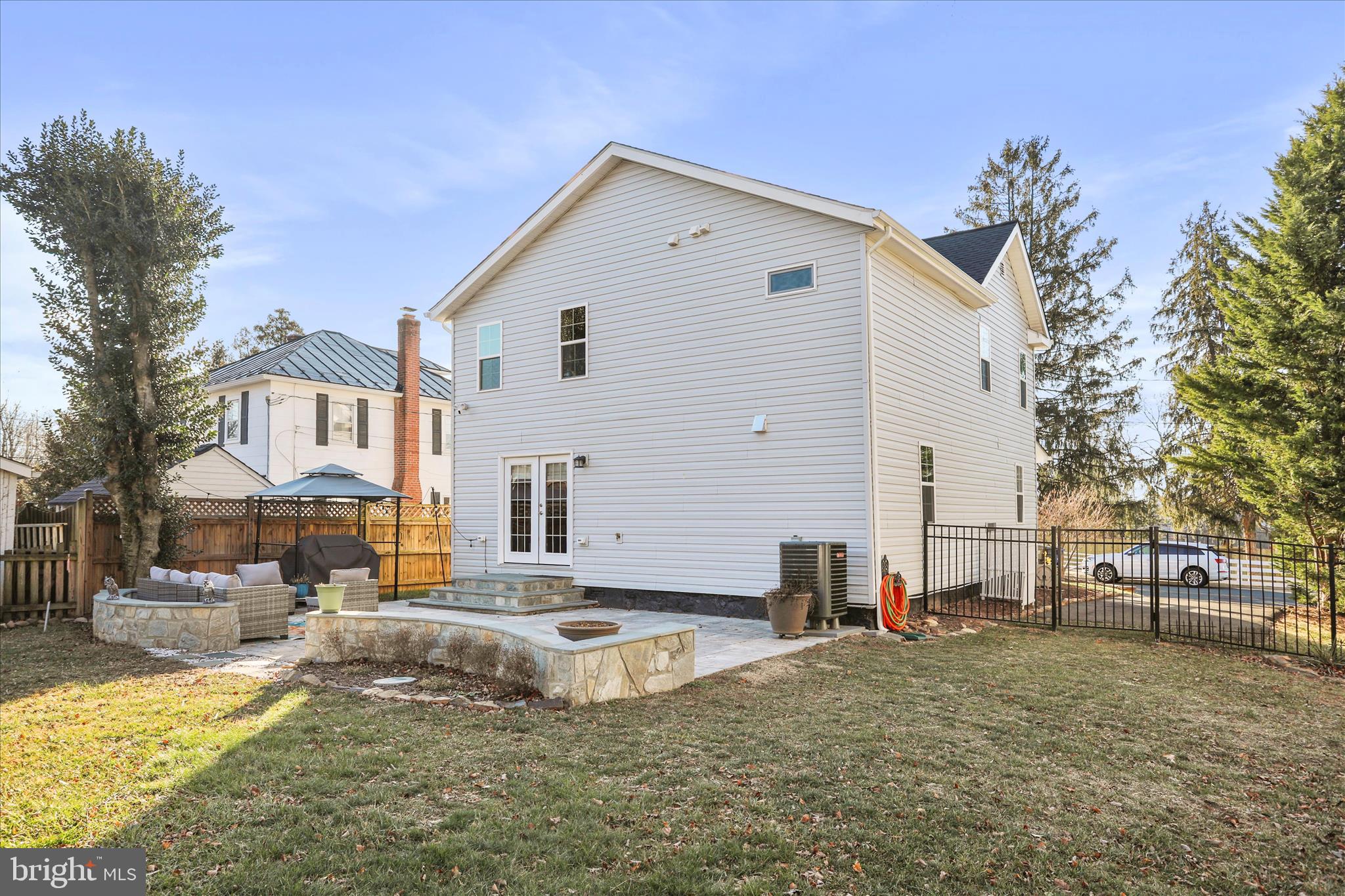 408 Blue Ridge Avenue Northeast Leesburg, VA 20176 - Photo 10 of 36 a view of a white house with a yard and a tree