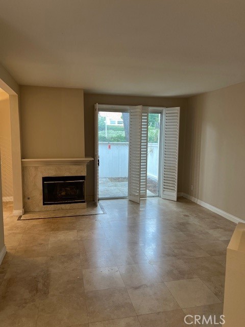 31 Chandon Laguna Niguel, CA 92677 - Photo 5 of 13 an empty room with windows and fireplace