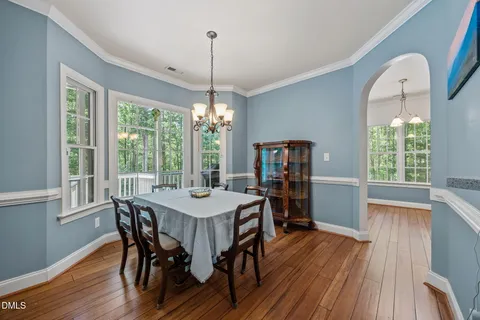 a kitchen with granite countertop a refrigerator and a stove top oven
