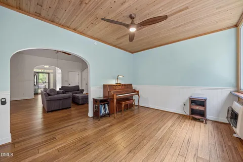 a kitchen with stainless steel appliances a refrigerator and wooden floor