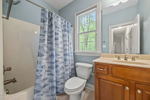 a bedroom with a bed and a ceiling fan