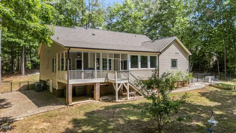 a view of a house with a yard and sitting area