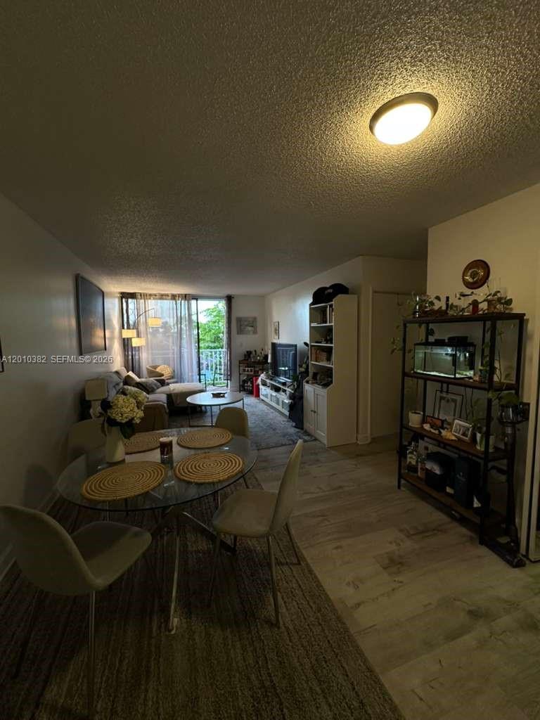 8261 Northwest 8th Street, Unit 423 Miami, FL 33126 - Photo 1 of 11 a living room with furniture and gym equipment