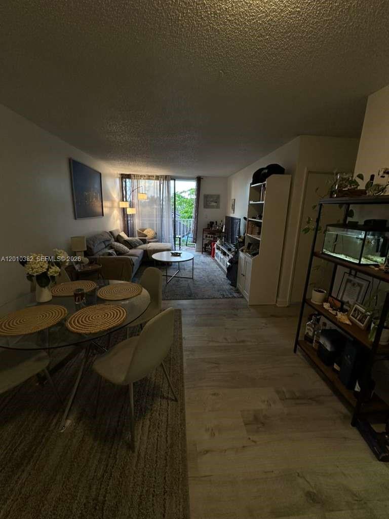 8261 Northwest 8th Street, Unit 423 Miami, FL 33126 - Photo 2 of 11 a living room with furniture a window and gym equipment