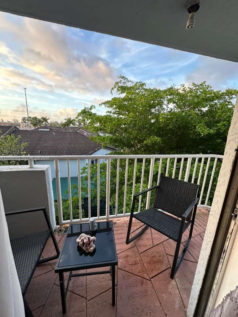 8261 Northwest 8th Street, Unit 423 Miami, FL 33126 - Photo 4 of 11 a view of a chairs and table in the roof deck