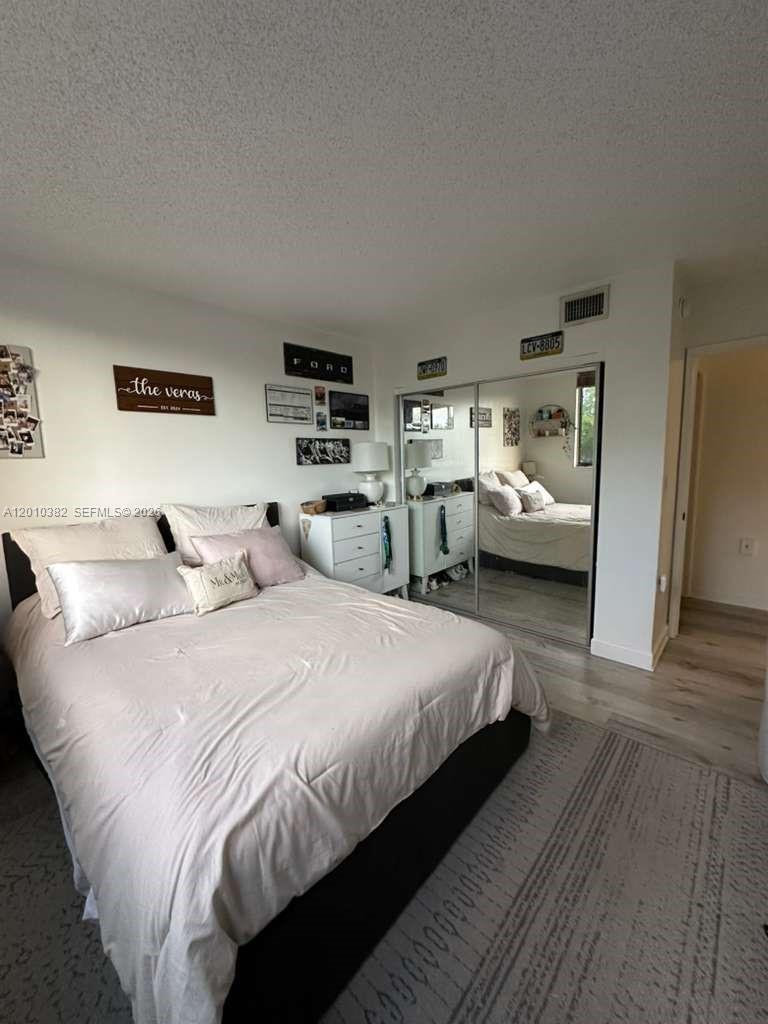 8261 Northwest 8th Street, Unit 423 Miami, FL 33126 - Photo 8 of 11 a bedroom with bed and window