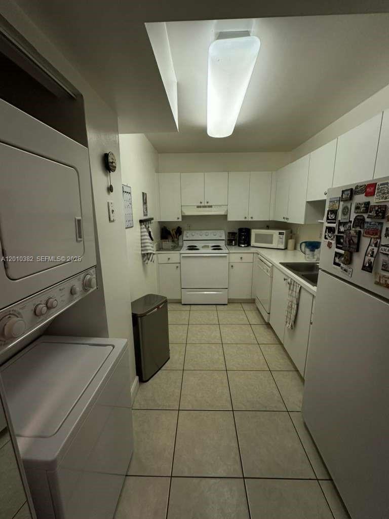 8261 Northwest 8th Street, Unit 423 Miami, FL 33126 - Photo 9 of 11 a kitchen with a sink a stove and cabinets