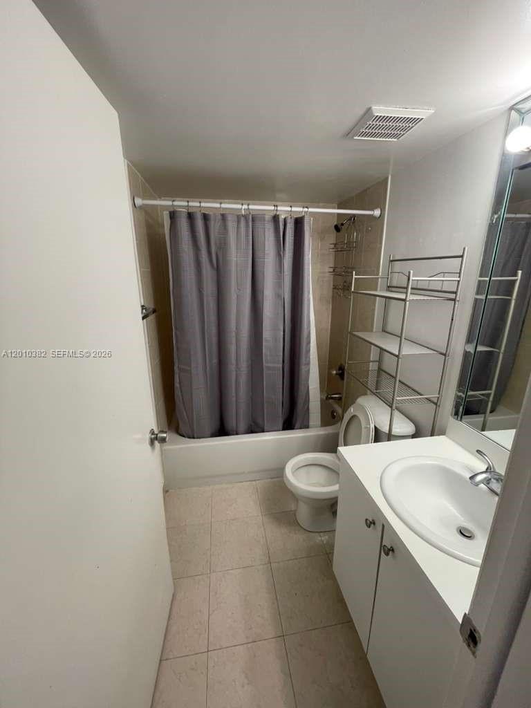8261 Northwest 8th Street, Unit 423 Miami, FL 33126 - Photo 10 of 11 a bathroom with a sink a toilet and shower