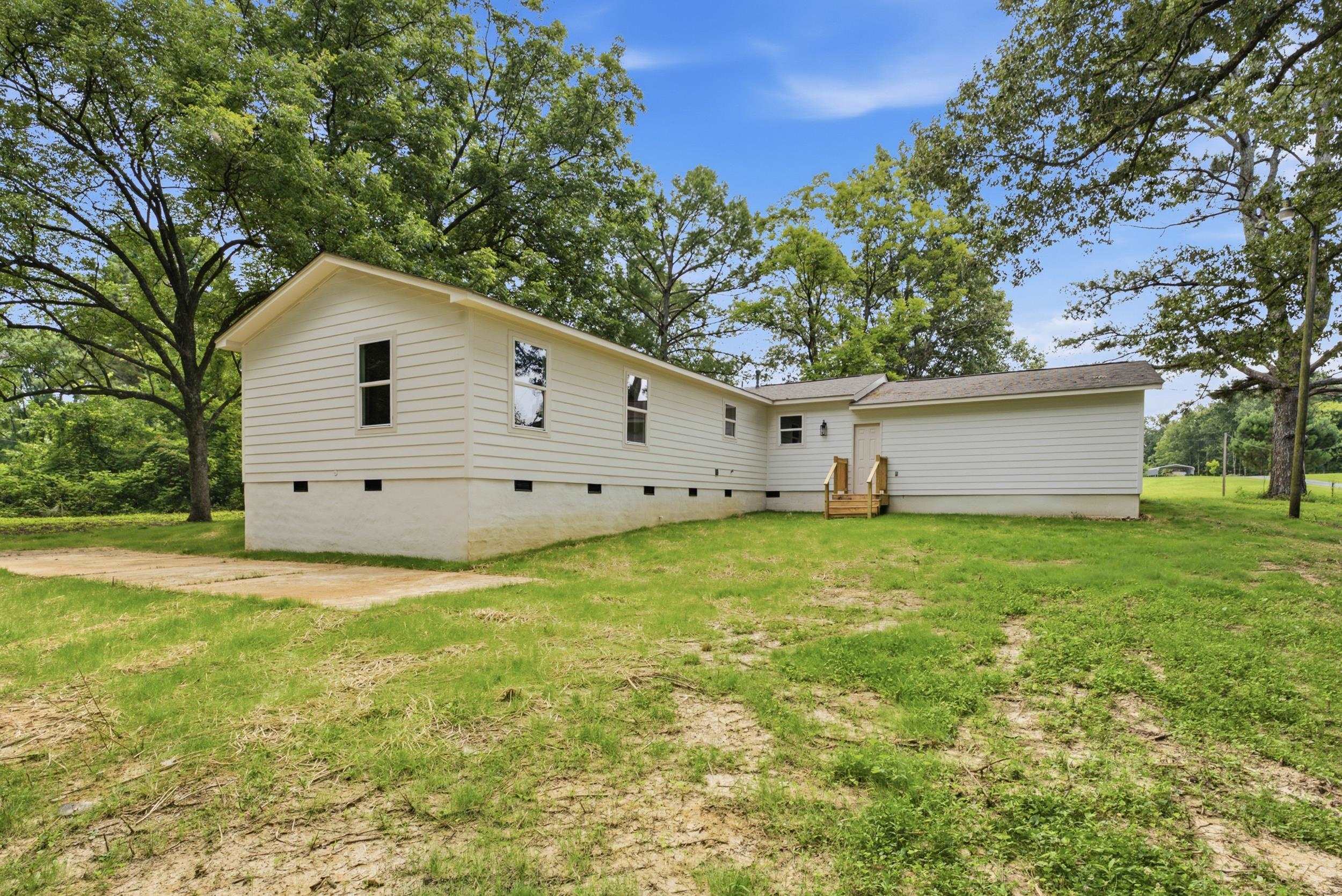 4683 Belmont Road Hernando, MS 38632 - Photo 4 of 21 Single-story residence featuring white horizontal siding, a light-colored foundation, and a partial concrete pad