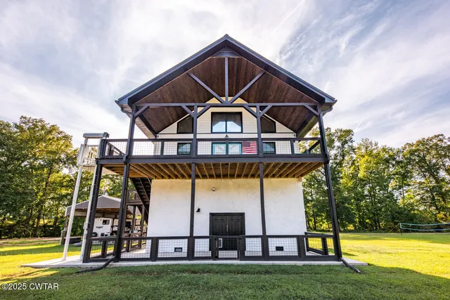 a view of a swimming pool with lawn chairs and a table