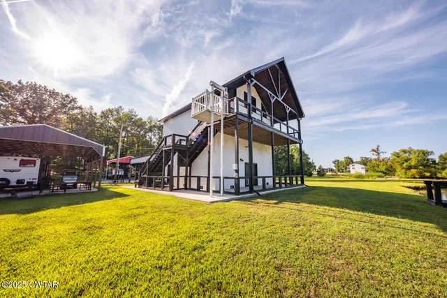an aerial view of a houses with a lake view