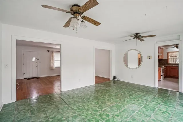 a view of a room with a barbeque and ceiling fan