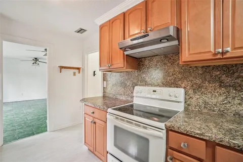 a kitchen with granite countertop cabinets stainless steel appliances and a sink