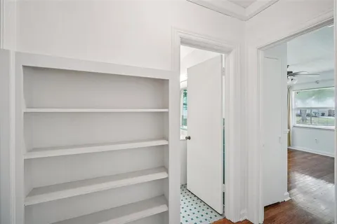 a view of walk in closet with empty racks
