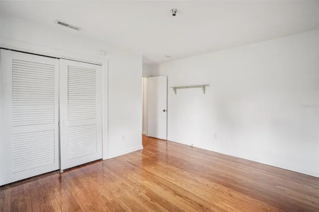 an empty room with wooden floor