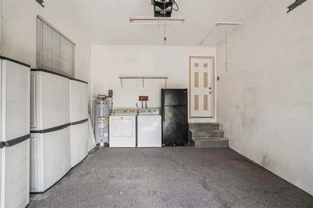 a view of kitchen with refrigerator and microwave