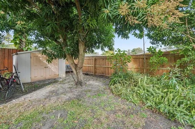 a backyard of a house with plants and lake view