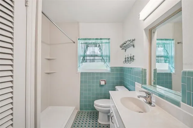 a bathroom with a sink toilet and shower