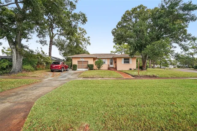 a front view of a house with yard and green space