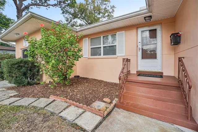 front view of a house with a bench