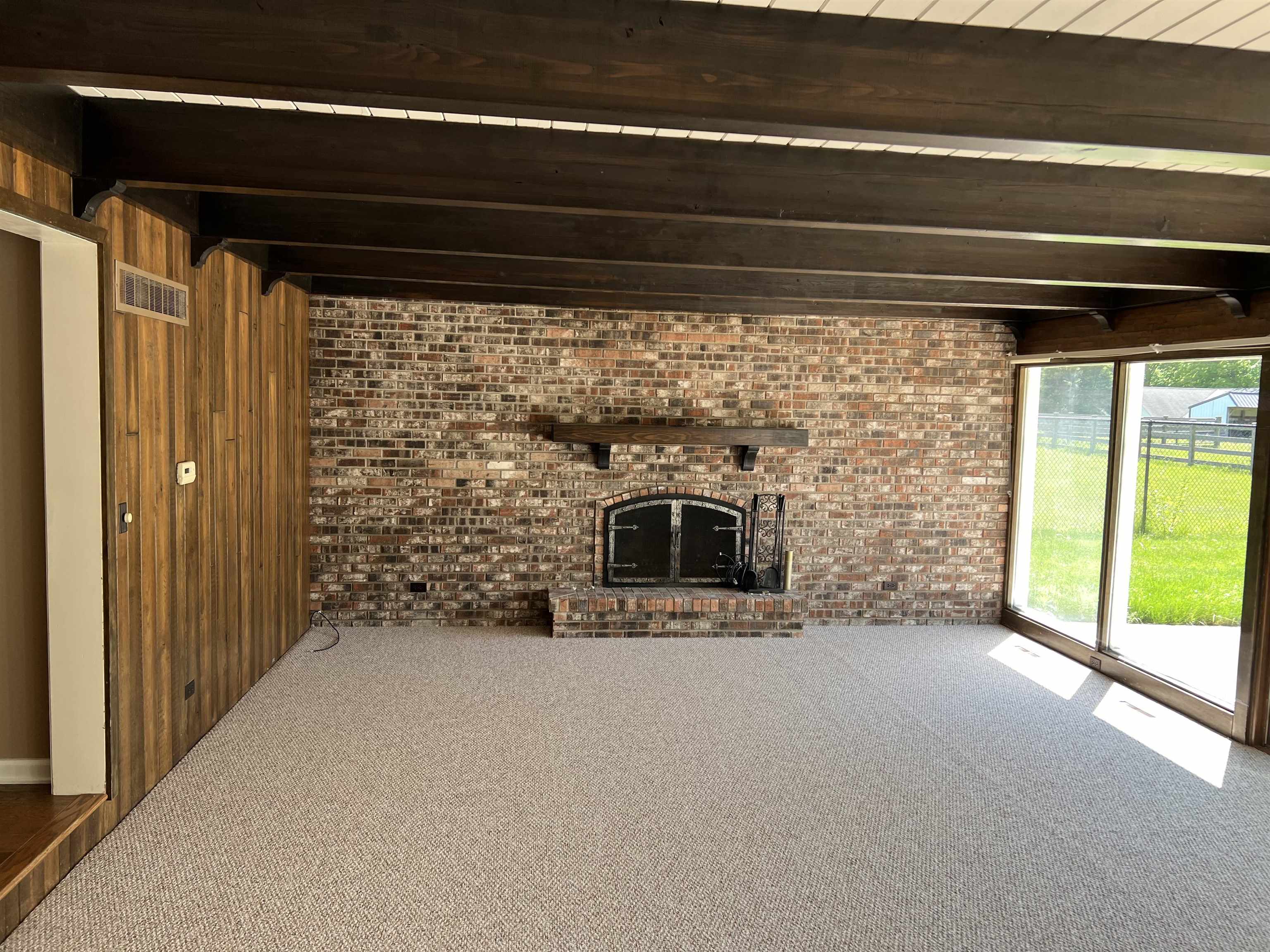 5382 Guilford Road Rockford, IL 61107 - Photo 18 of 66 a view of empty room with a fireplace and a floor to ceiling window