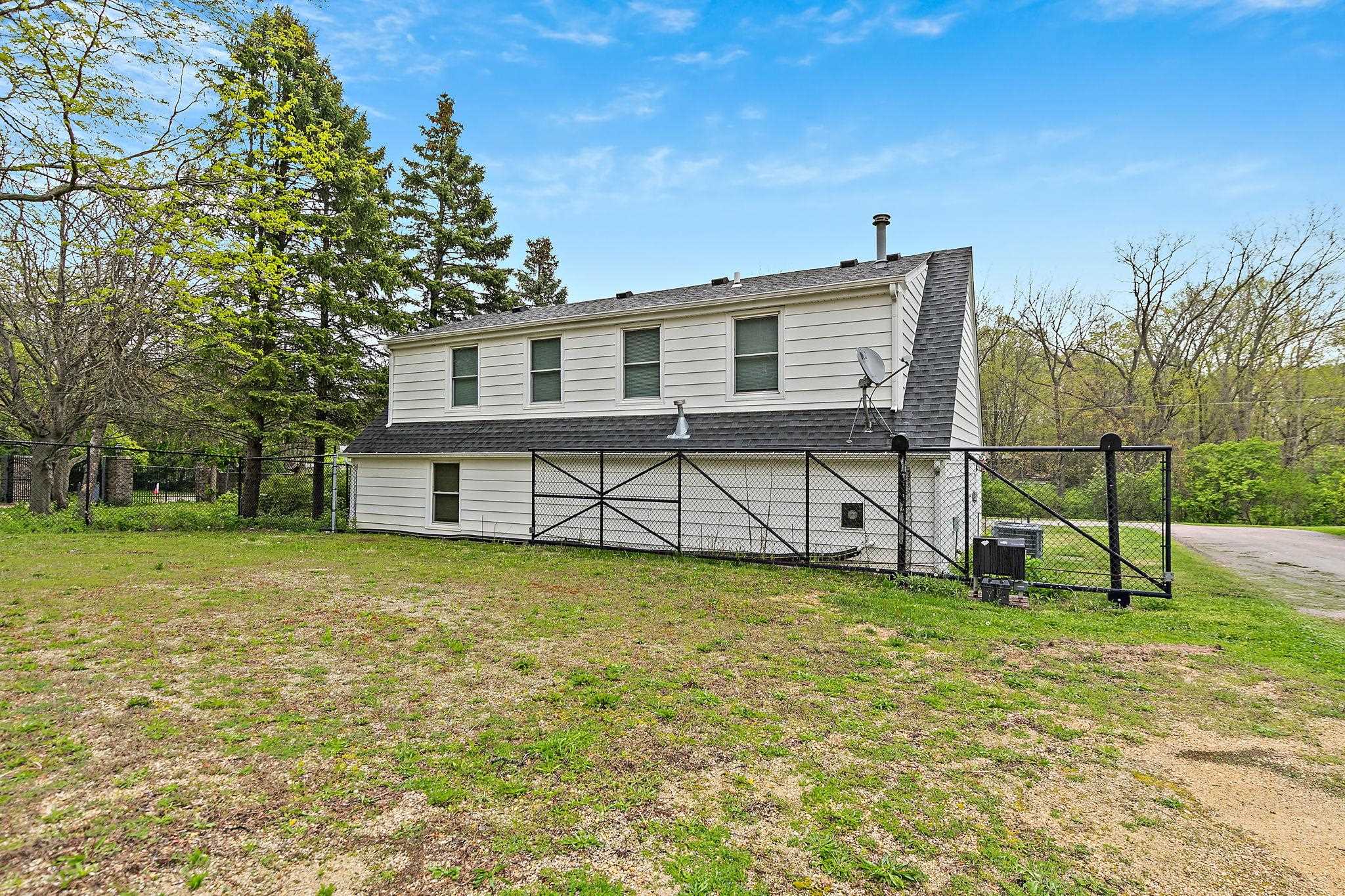5382 Guilford Road Rockford, IL 61107 - Photo 23 of 72 a view of a house with a yard and sitting area