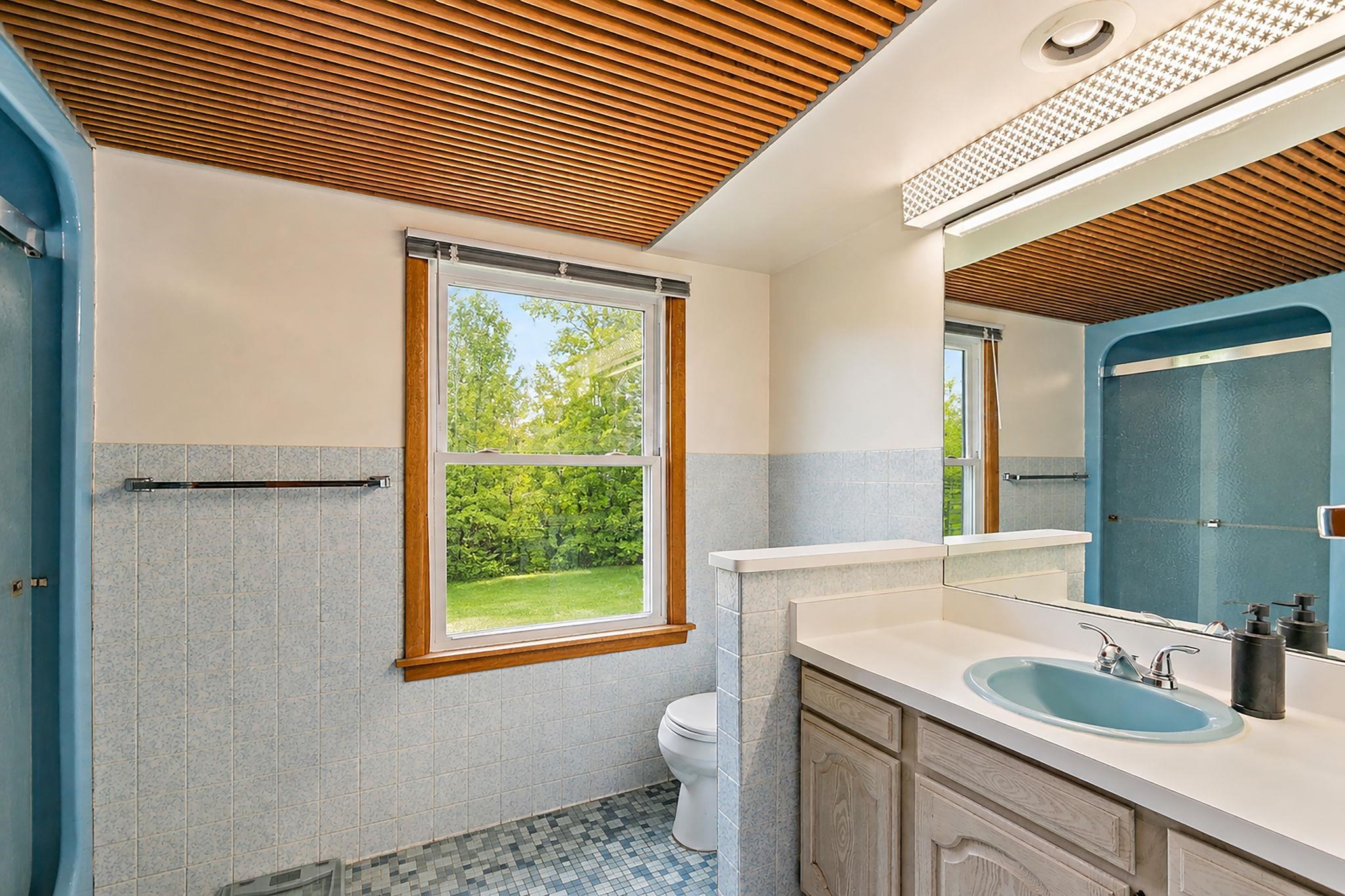 5382 Guilford Road Rockford, IL 61107 - Photo 28 of 72 a bathroom with a granite countertop sink and a toilet