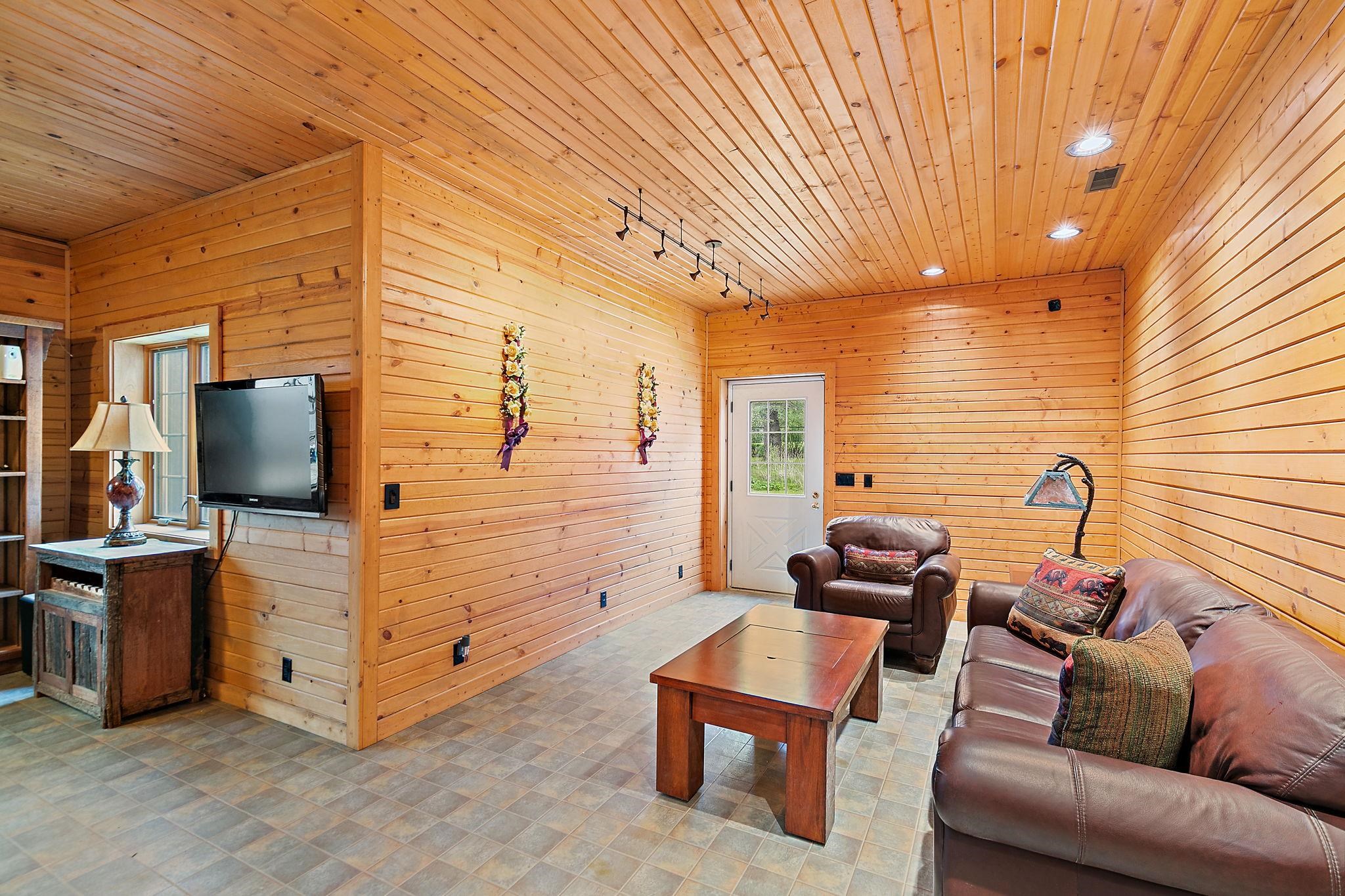 5382 Guilford Road Rockford, IL 61107 - Photo 42 of 72 a living room with furniture and a flat screen tv