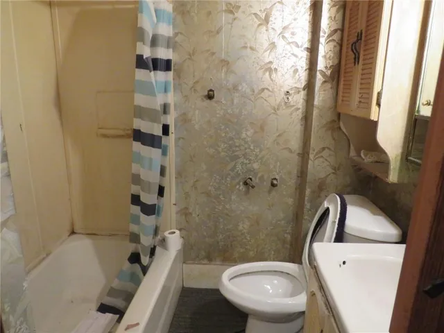 a bedroom with a bed and a tv