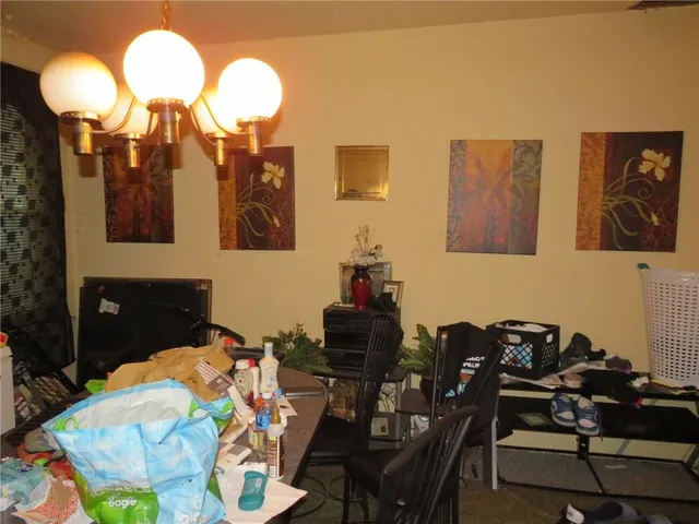 a dining room with furniture and a chandelier