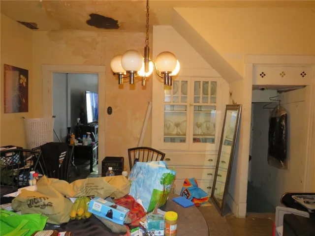 a bedroom with bed and a mirror