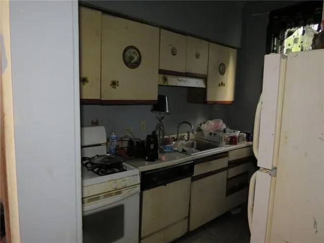 a kitchen with stainless steel appliances a sink stove and cabinets