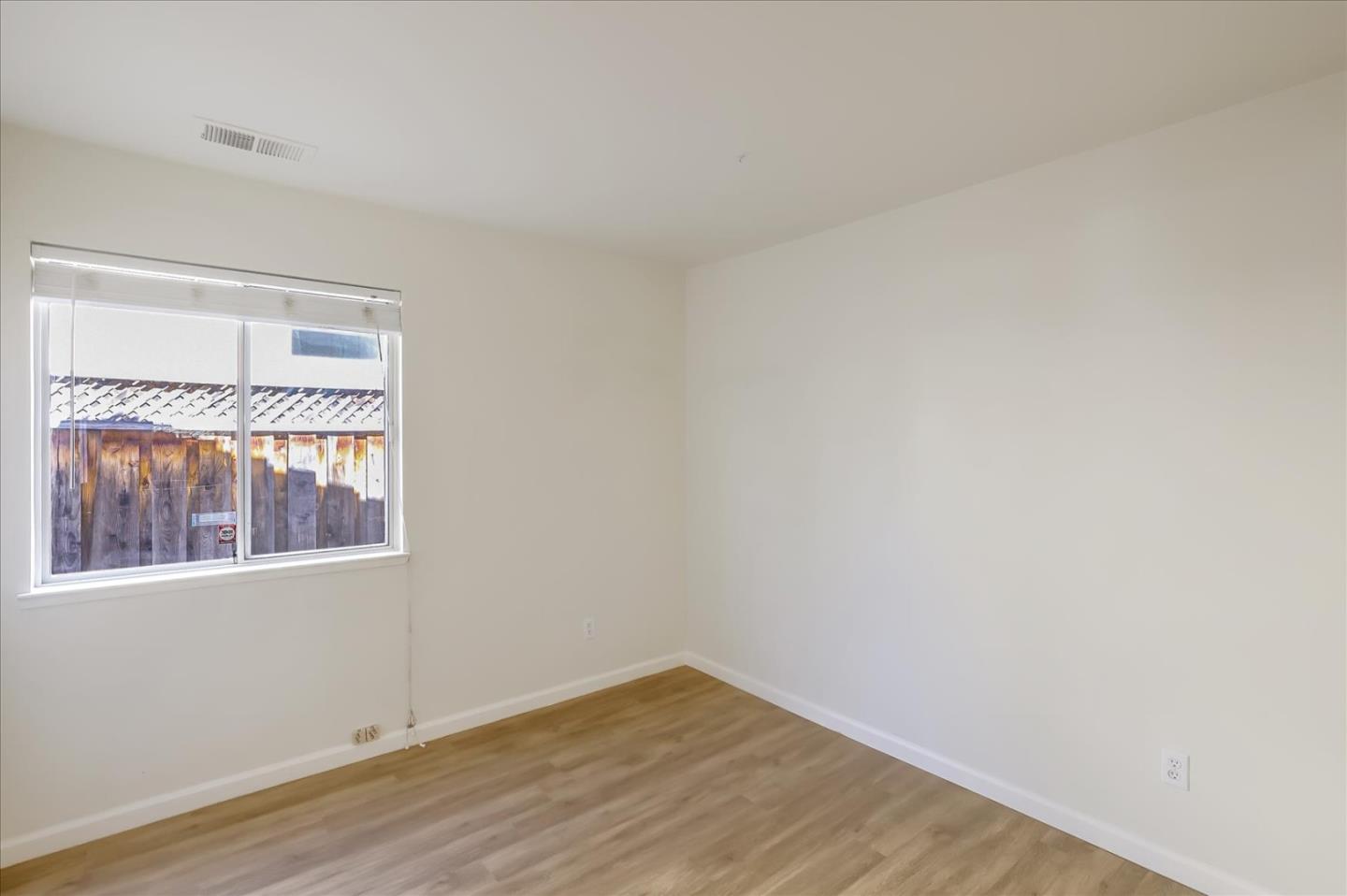 1274 Blacksmith Drive Gilroy, CA 95020 - Photo 19 of 30 a view of an empty room with wooden floor and a window