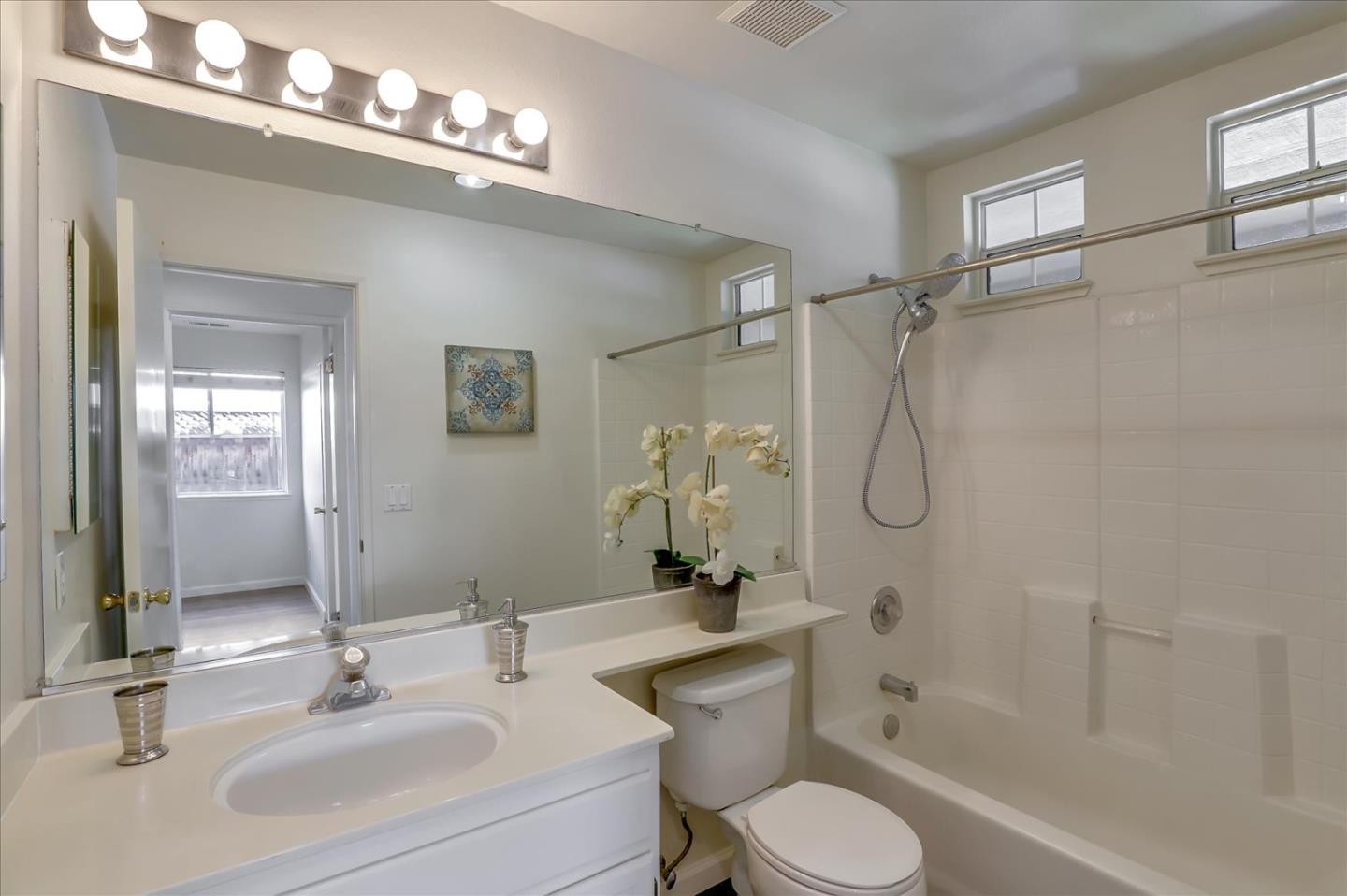 1274 Blacksmith Drive Gilroy, CA 95020 - Photo 22 of 30 a bathroom with a sink toilet a mirror and shower