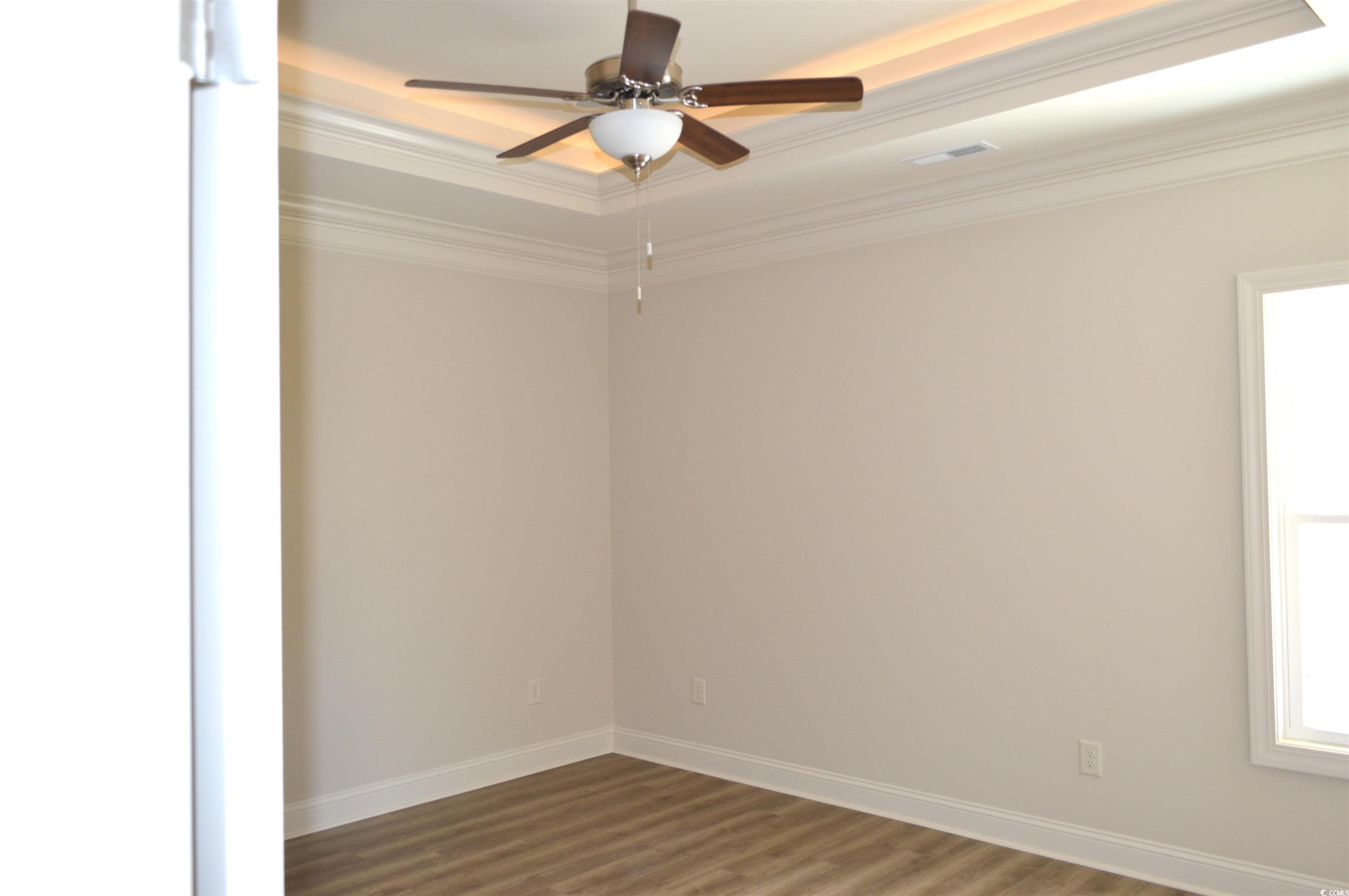 108 Hallandale Lane, Unit RIGHT Murrells Inlet, SC 29576 - Photo 14 of 35 Owners bedroom with crown molding, and a tray ceiling