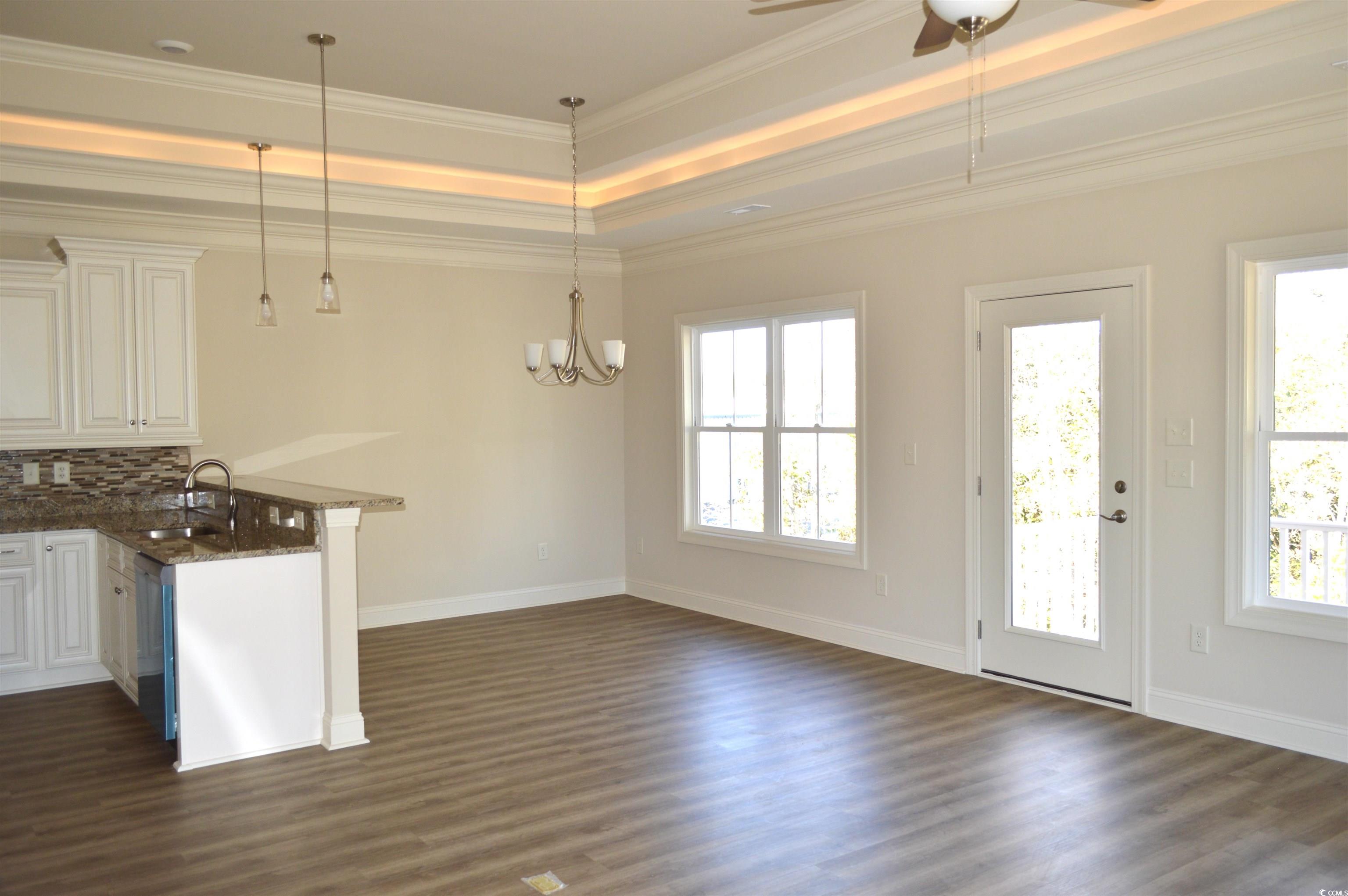 108 Hallandale Lane, Unit RIGHT Murrells Inlet, SC 29576 - Photo 5 of 35 Kitchen with kitchen peninsula, ornamental molding, sink, pendant lighting, and off white cabinetry