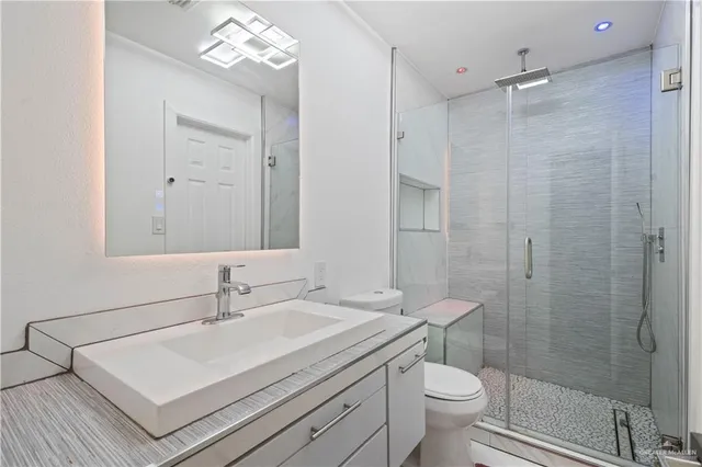 a bathroom with a sink toilet and shower