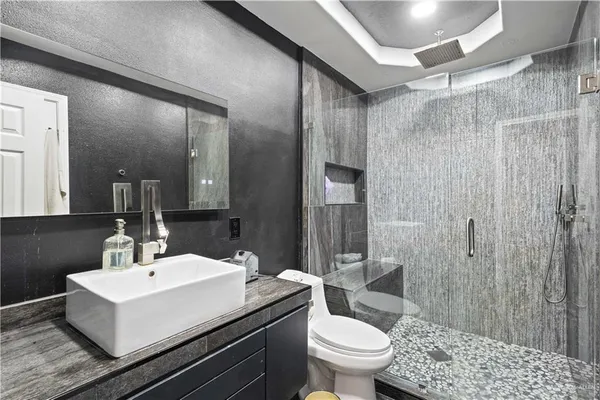 a bathroom with a sink toilet and shower