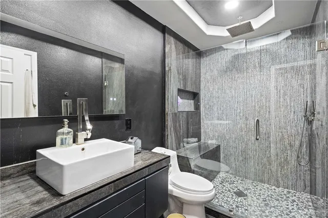 a bathroom with a sink toilet and shower