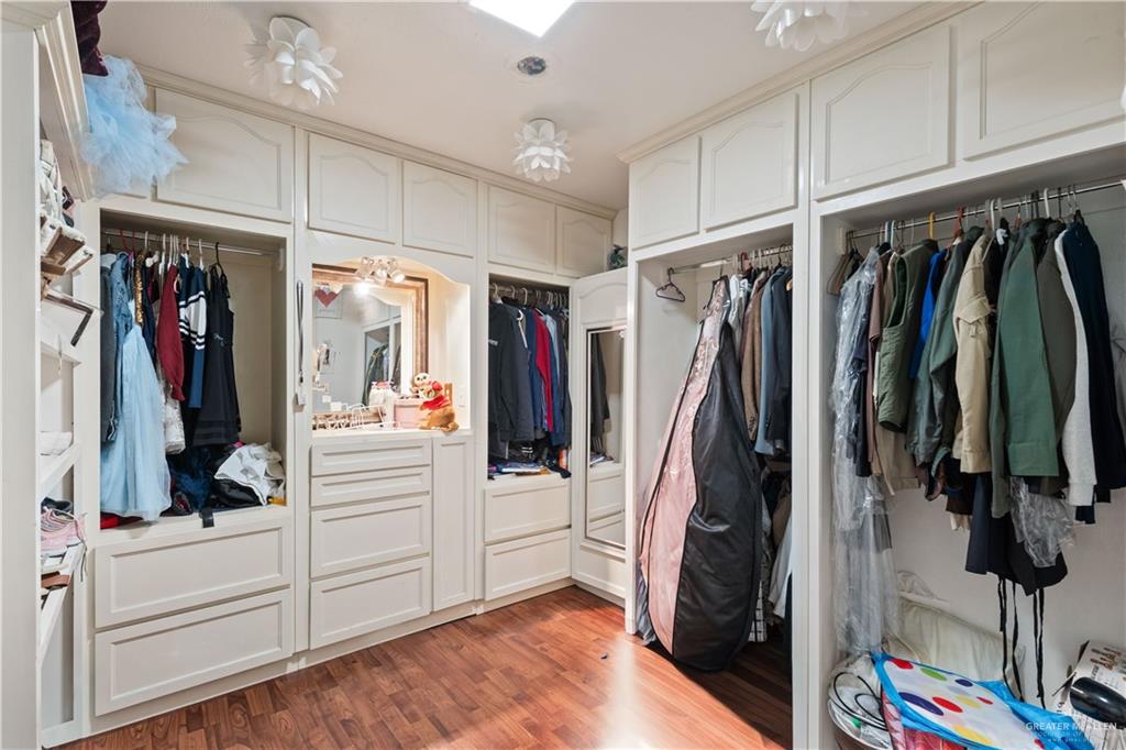 415 North 8th Street Hidalgo, TX 78557 - Photo 15 of 21 a view of walk in closet with clothes and shoes