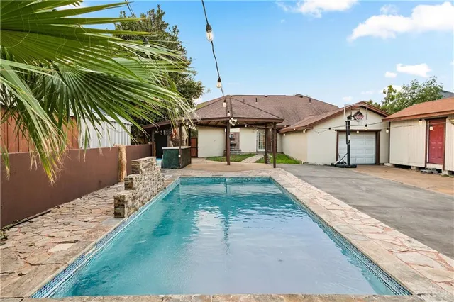 a house with swimming pool in front of it