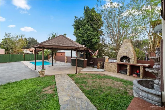 a front view of a house with garden and sitting area