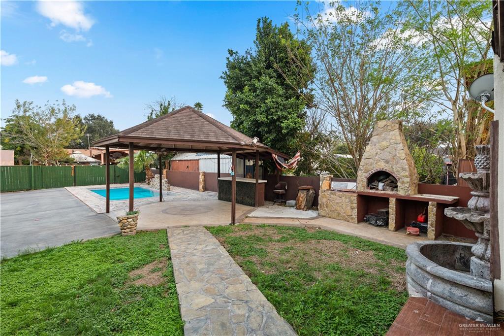 415 North 8th Street Hidalgo, TX 78557 - Photo 19 of 21 a front view of a house with garden and sitting area